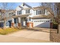 Attractive two-story home with a welcoming front porch, two-car garage, and nice driveway at 1271 Sky Rock Way, Castle Rock, CO 80109