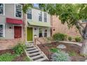 Charming townhome with colorful awnings, brick facade, landscaped front yard, and inviting curb appeal at 1150 Inca St # 43, Denver, CO 80204