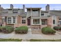 Charming townhome with a mix of brick and siding, complemented by well-manicured bushes, enhancing its curb appeal at 15149 E Princeton Pl # D, Aurora, CO 80014