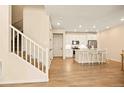 A staircase in an open living space leads to a modern kitchen with a center island at 8055 Navajo River Loop # B, Littleton, CO 80125