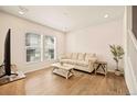 Bright living room with hardwood floors, large windows and a comfortable sofa at 8055 Navajo River Loop # B, Littleton, CO 80125