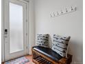 Inviting entryway with coat hooks, a comfortable bench, and a welcoming rug by the door at 8187 Martin Luther King Blvd, Denver, CO 80238