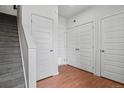 Bright hallway with a staircase and multiple white doors, offering ample storage space at 8187 Martin Luther King Blvd, Denver, CO 80238