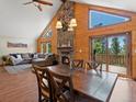 Dining room with wood floors, a fireplace, and views of the outdoor scenery at 30382 Kings Valley East, Conifer, CO 80433