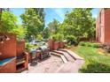 Charming patio area with outdoor kitchen, built-in grill, and beautiful brickwork for entertaining at 625 Pearl St # 23, Boulder, CO 80302