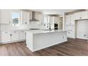 Stylish kitchen featuring a large center island, white cabinets, stainless appliances, and subway tile at 4728 Twelve Oaks Way, Castle Rock, CO 80104