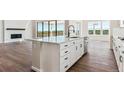 Open-concept kitchen island with modern finishes, stainless appliances, and hardwood floors at 4728 Twelve Oaks Way, Castle Rock, CO 80104