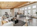 Spacious living area with modern design, bright white walls, and wood plank ceiling at 2650 W Asbury Ave, Denver, CO 80219