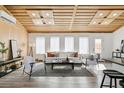 Cozy living room with a modern design including wood plank ceiling and bright natural light at 2650 W Asbury Ave, Denver, CO 80219