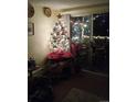 Bright living room with a Christmas tree and patio doors at 1300 S Parker Rd # 305, Denver, CO 80231