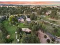 Expansive aerial view showcasing the home, pool, golf green, pond and lush landscaping on the property at 10145 Meadow Run, Parker, CO 80134