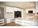 Modern white kitchen with stainless steel appliances, granite countertops, and ample cabinet space at 10554 Tanglewood Rd, Franktown, CO 80116