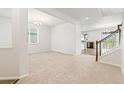 Bright living room with neutral carpet, white walls and an open floor plan at 1356 Castle Creek Cir, Castle Rock, CO 80104