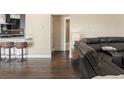 A glimpse of a modern living room with hardwood floors and comfortable seating, leading to the kitchen at 7669 Pecos St, Denver, CO 80221