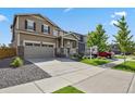 Charming home with a two-car garage, lush lawn, and inviting curb appeal at 13144 E 109Th Pl, Commerce City, CO 80022