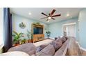 Cozy living room boasts a large sectional sofa, decorative plants, and a wooden media center at 13144 E 109Th Pl, Commerce City, CO 80022