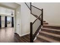 Elegant staircase with dark wood railing and carpeted steps, leading to the upper level at 13144 E 109Th Pl, Commerce City, CO 80022