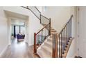 Bright foyer with a carpeted staircase and wood and iron railing leading to the upper level at 13144 E 109Th Pl, Commerce City, CO 80022