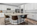 Spacious kitchen with white cabinets, stainless steel appliances, granite countertops, and a large central island at 1425 Hart Ln, Elizabeth, CO 80107