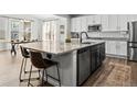 Kitchen with black island, granite countertops, stainless steel appliances and breakfast bar at 1425 Hart Ln, Elizabeth, CO 80107