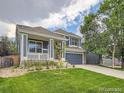 Stylish two-story home features a covered front porch, stone accents, and a well-maintained lawn at 9865 Centre Cir, Parker, CO 80134