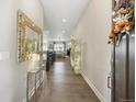 Bright entryway with hardwood floors, offering a glimpse into the home's open floor plan at 16902 W 94Th Pl, Arvada, CO 80007