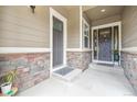 Inviting covered entryway with stone accents, showcasing a welcoming entrance to the home at 16902 W 94Th Pl, Arvada, CO 80007