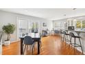 Dining room with wood floors, a large table, and easy access to the outdoor balcony at 5058 E Cherry Creek South Dr, Denver, CO 80246