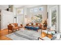Bright living room featuring large windows, hardwood floors, and stylish furnishings at 5058 E Cherry Creek South Dr, Denver, CO 80246