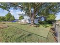 Charming house on a green lawn, shaded by a large, mature tree at 2105 S Irving St, Denver, CO 80219