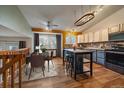 Modern kitchen with stainless steel appliances, a center island with bar seating, and stylish lighting at 11539 Depew Ct, Westminster, CO 80020