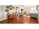 Open-concept living space with hardwood floors, stylish furnishings, and a cozy seating area; great for entertaining at 4456 S Washington St, Englewood, CO 80113