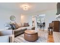 Bright and airy living room that flows into dining area, showcasing hardwood floors and neutral decor at 9580 W 12Th Pl, Lakewood, CO 80215
