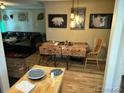 Cozy dining room with unique decor, hardwood floors, and a view into the living room at 1207 Joliet St, Aurora, CO 80010