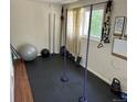 Home gym with black floors and gym equipment, featuring a large window at 1207 Joliet St, Aurora, CO 80010