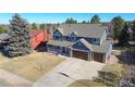 Expansive aerial view of a two-story home with a large driveway and mature trees at 6526 N Windfield Ave, Parker, CO 80134