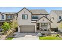 Charming two-story home with landscaped front yard, covered porch, and attached two car garage at 9140 Moondance Sw Dr, Littleton, CO 80125