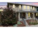 Two-story home showcases a covered front porch, nice paint scheme, and mature landscaping at 2820 Macon Way, Denver, CO 80238