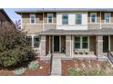 Charming two-story home with a covered front porch, brick pillars, and well-maintained landscaping at 2820 Macon Way, Denver, CO 80238