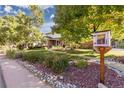 Landscaped front yard featuring rock beds and lush green grass at 6906 S Sycamore St, Littleton, CO 80120