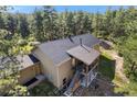 Aerial shot of a home with a covered patio, well maintained roof, and stairs leading to the entrance at 11044 Conestoga Pl, Franktown, CO 80116