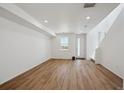 Bright living room featuring hardwood floors, large window and white walls at 1224 Penner Dr, Erie, CO 80026