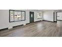 Inviting living room with bay windows and stylish, updated flooring at 7810 Larkwood St, Commerce City, CO 80022