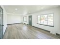 Spacious living room with large windows providing ample natural light at 7810 Larkwood St, Commerce City, CO 80022