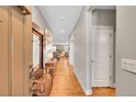 Inviting hallway with hardwood floors, leading to a living area with a fireplace at 6670 Club Villa Rd, Parker, CO 80134
