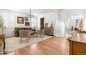 Bright living room with hardwood floors, plantation shutters, a stylish rug, and elegant decor at 12032 Triple Crown Dr, Parker, CO 80134