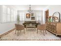 Bright living room with hardwood floors, plantation shutters, a stylish rug, and elegant decor at 12032 Triple Crown Dr, Parker, CO 80134