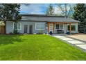 Beautifully landscaped front yard with lush green grass and a cozy covered entryway at 4790 E Dartmouth Ave, Denver, CO 80222