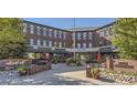 Picturesque community plaza with brick pathways, outdoor seating, and charming storefronts at 10976 Snowdon St, Parker, CO 80134