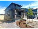 Charming two-story home with a welcoming front porch, a two-car garage, and xeriscaped front yard at 10976 Snowdon St, Parker, CO 80134